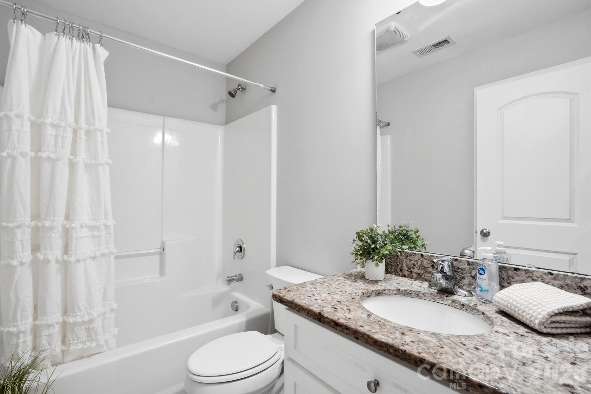 2122 Centergrove Road Kannapolis, NC 28083 - Photo 29 of 47 a bathroom with a granite countertop sink toilet mirror and shower