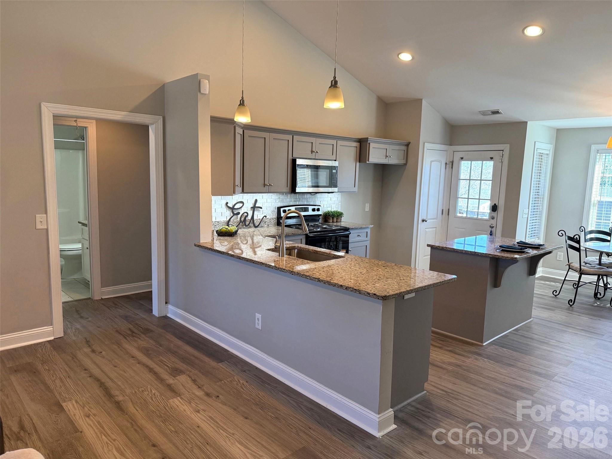 2122 Centergrove Road Kannapolis, NC 28083 - Photo 10 of 47 a kitchen with stainless steel appliances granite countertop wooden cabinets and wooden floor