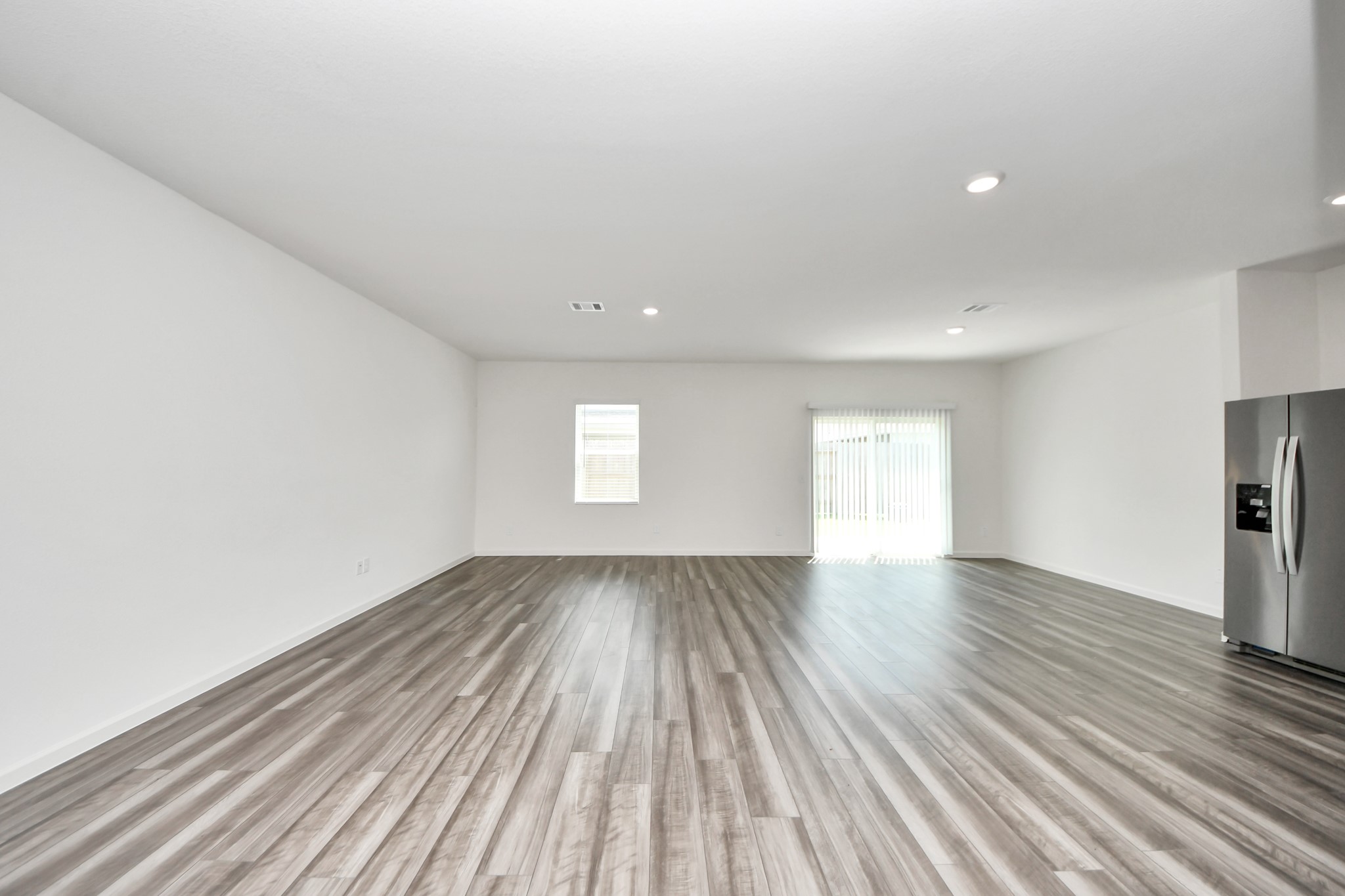 10306 Tuscan Valley Drive Rosharon, TX 77583 - Photo 17 of 48 a view of an empty room with wooden floor and a window