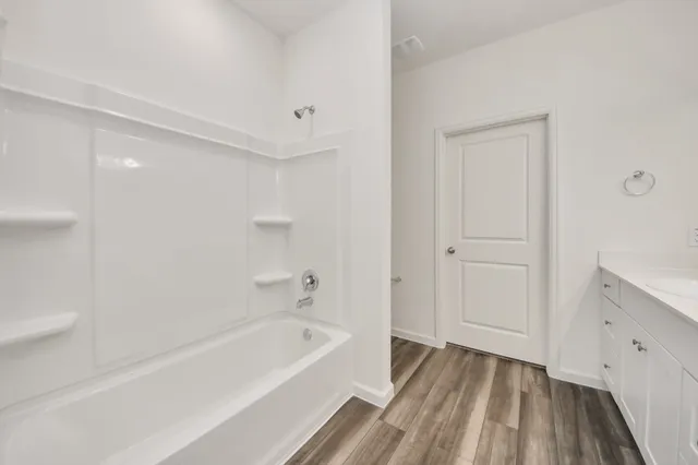 a bathroom with a sink vanity and a mirror