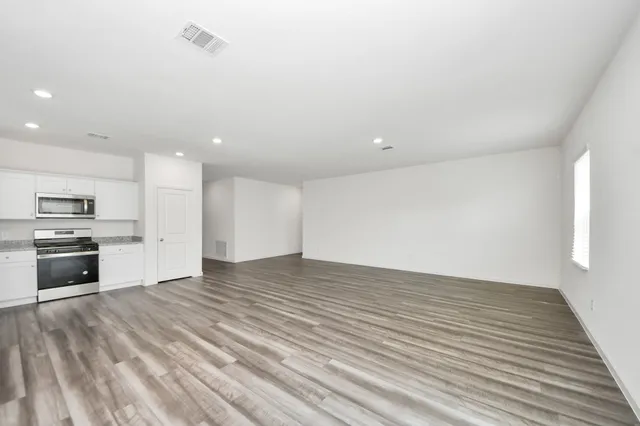 a view of kitchen stove microwave and cabinets