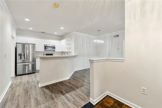 a kitchen with a refrigerator a sink and cabinets