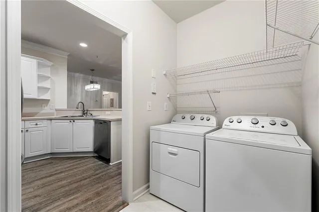 a view of a kitchen with wooden floor and a window