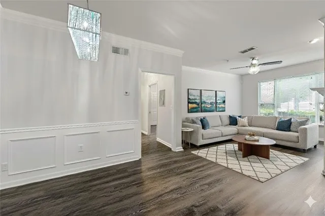 an empty room with wooden floor mirror and windows