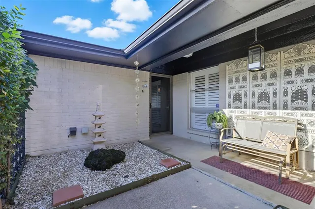 a house with yard and a potted plant