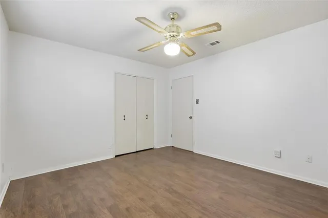 a bathroom with a granite countertop sink a toilet and a shower