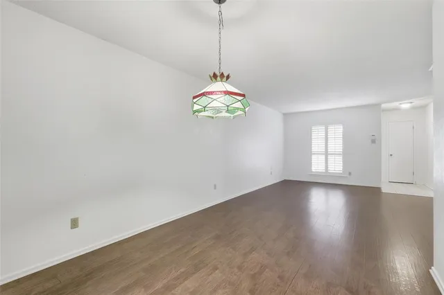 a hallway with a window and a chandelier