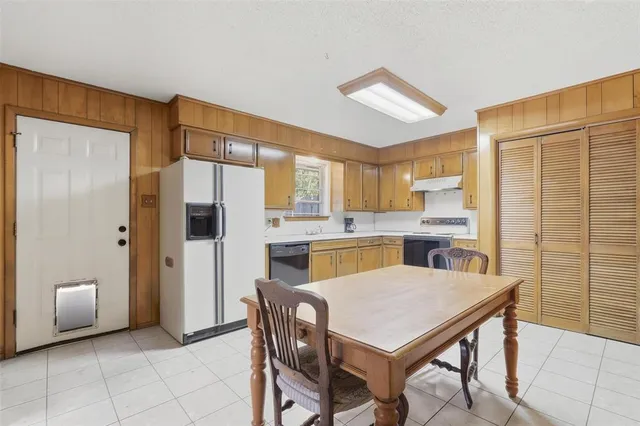 a kitchen with stainless steel appliances a stove a refrigerator and a refrigerator