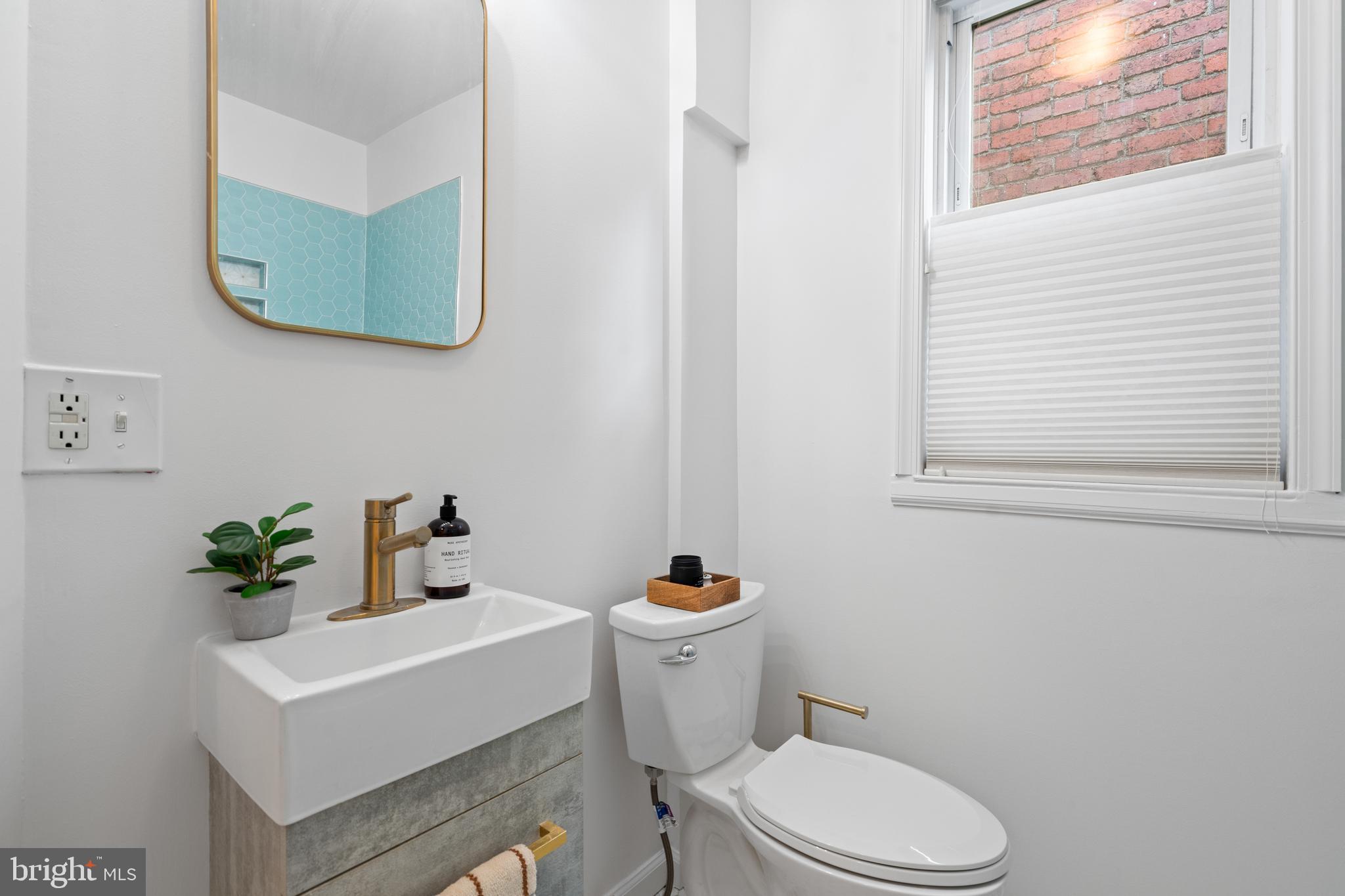 525 14th Street Southeast Washington, DC 20003 - Photo 29 of 41 a white toilet sitting next to a bathroom sink