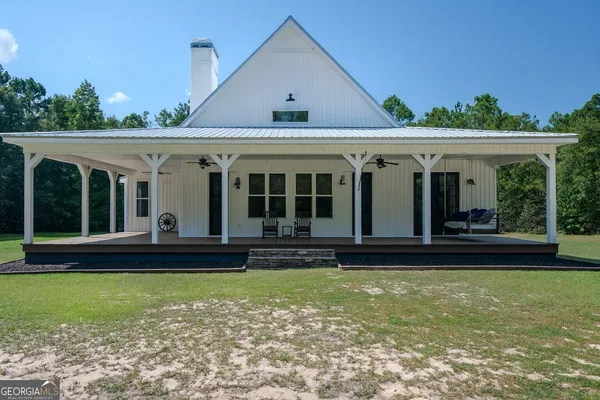 a view of a house with swimming pool and porch