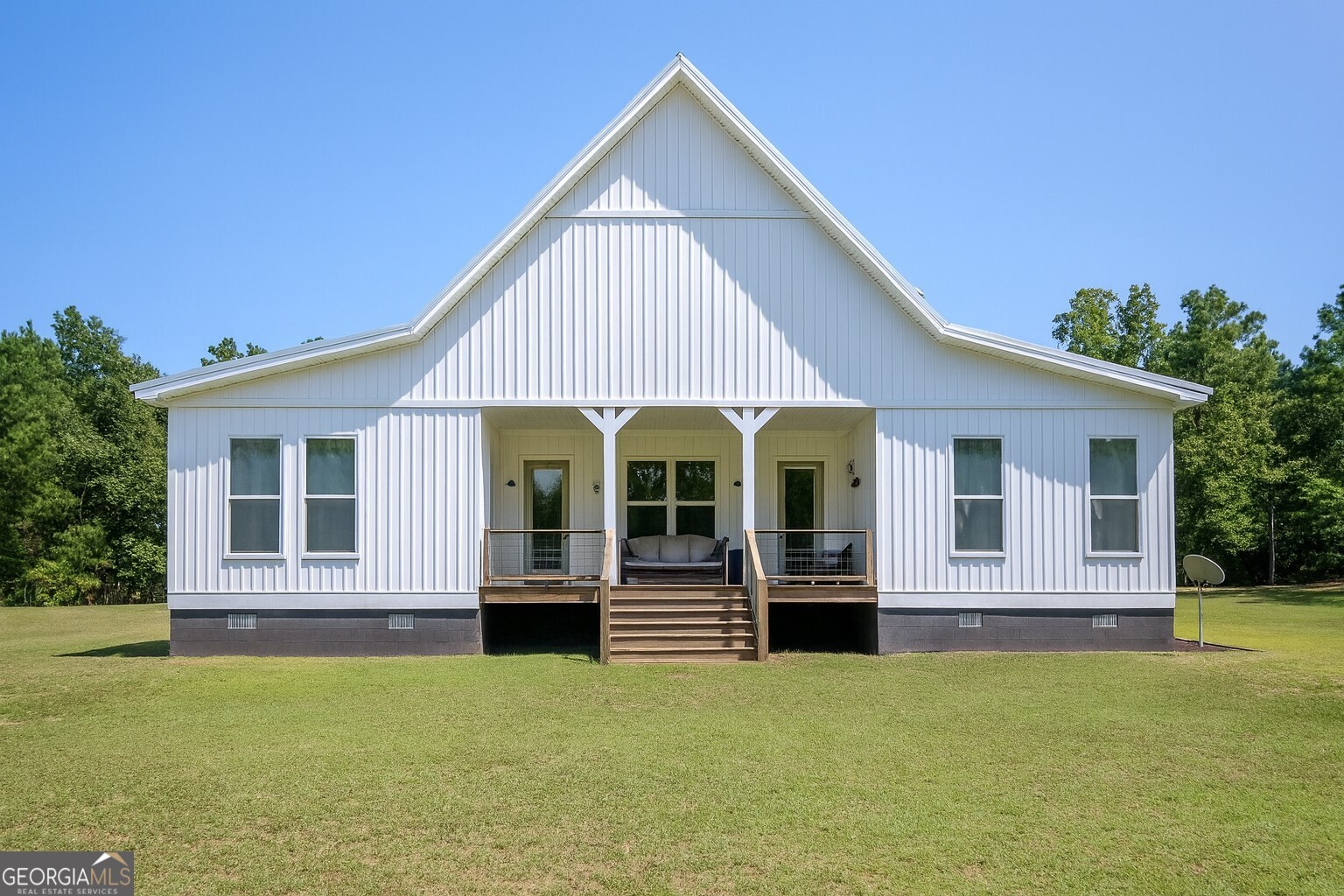 221 Butler Road Southeast Milledgeville, GA 31061 - Photo 12 of 60 a view of a house with a yard and potted plants