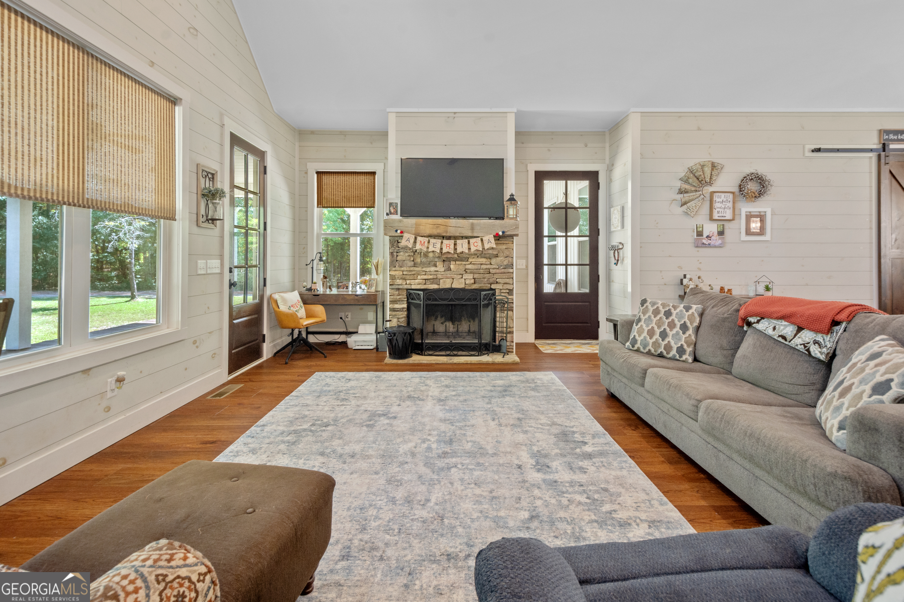 221 Butler Road Southeast Milledgeville, GA 31061 - Photo 27 of 60 a living room with furniture flat screen tv and a fireplace