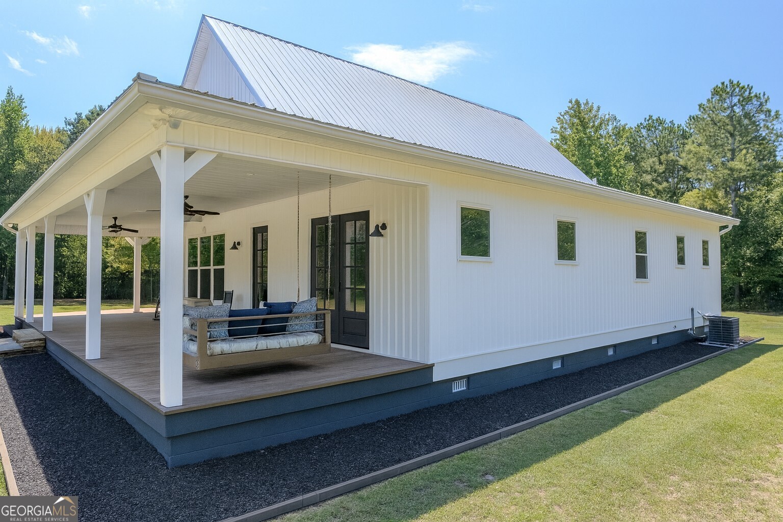 221 Butler Road Southeast Milledgeville, GA 31061 - Photo 3 of 60 a view of a house with backyard sitting area and porch