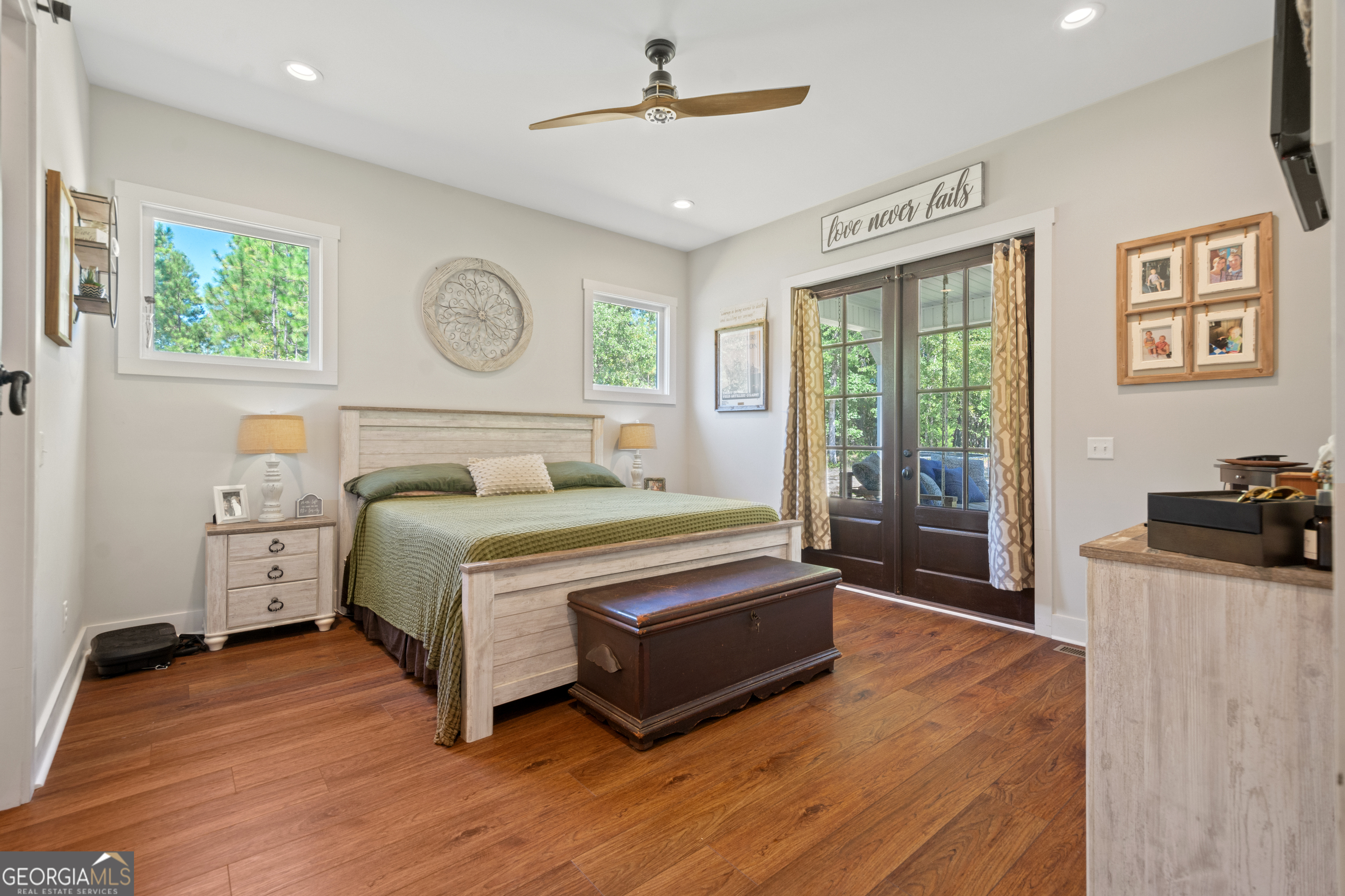 221 Butler Road Southeast Milledgeville, GA 31061 - Photo 32 of 60 a bedroom with a bed and a dresser with wooden floor
