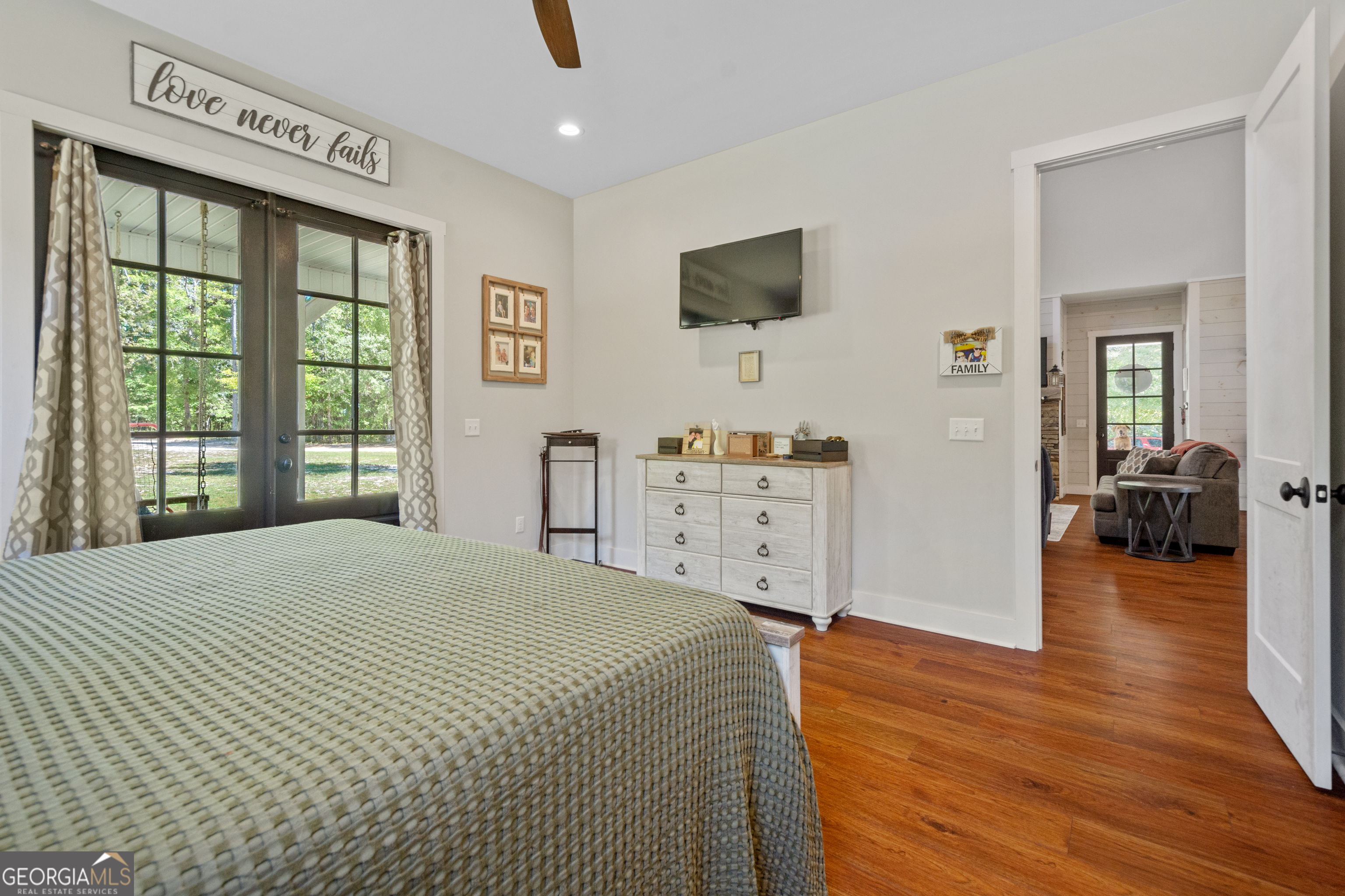 221 Butler Road Southeast Milledgeville, GA 31061 - Photo 34 of 60 a bedroom with a bed and a flat tv screen on dresser