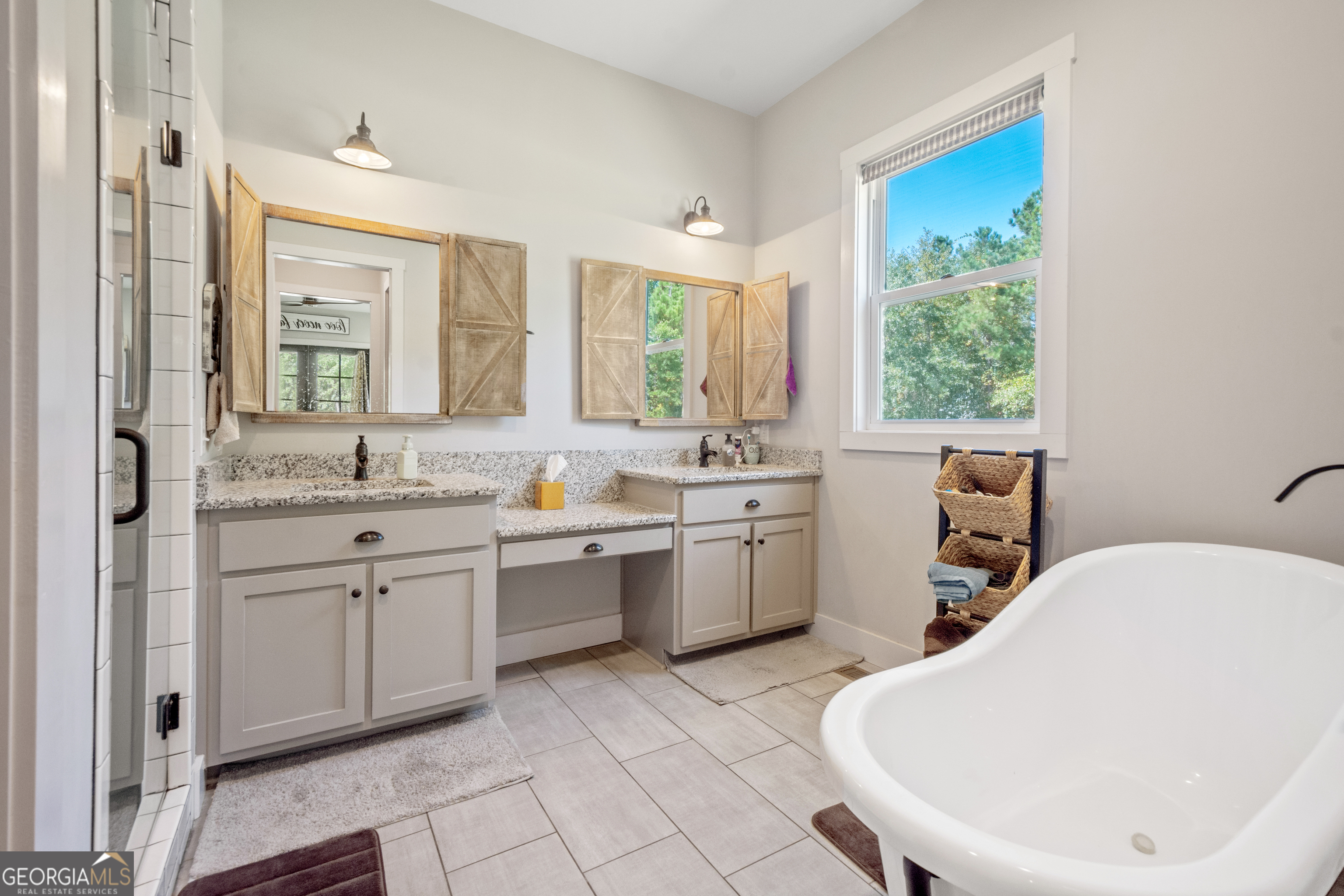 221 Butler Road Southeast Milledgeville, GA 31061 - Photo 38 of 60 a bathroom with a granite countertop sink mirror and a bathtub