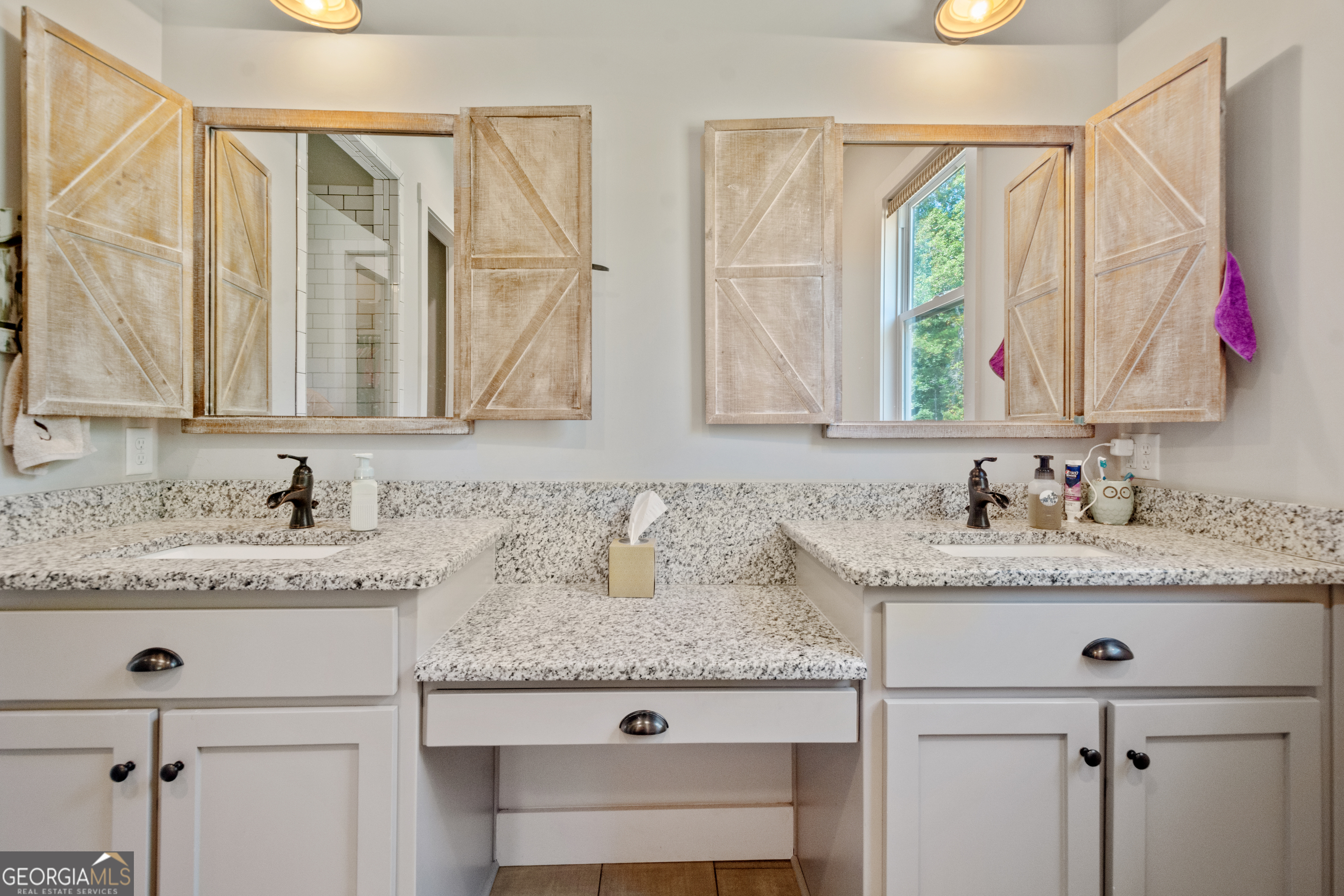 221 Butler Road Southeast Milledgeville, GA 31061 - Photo 39 of 60 a bathroom with a granite countertop sink a mirror and a window