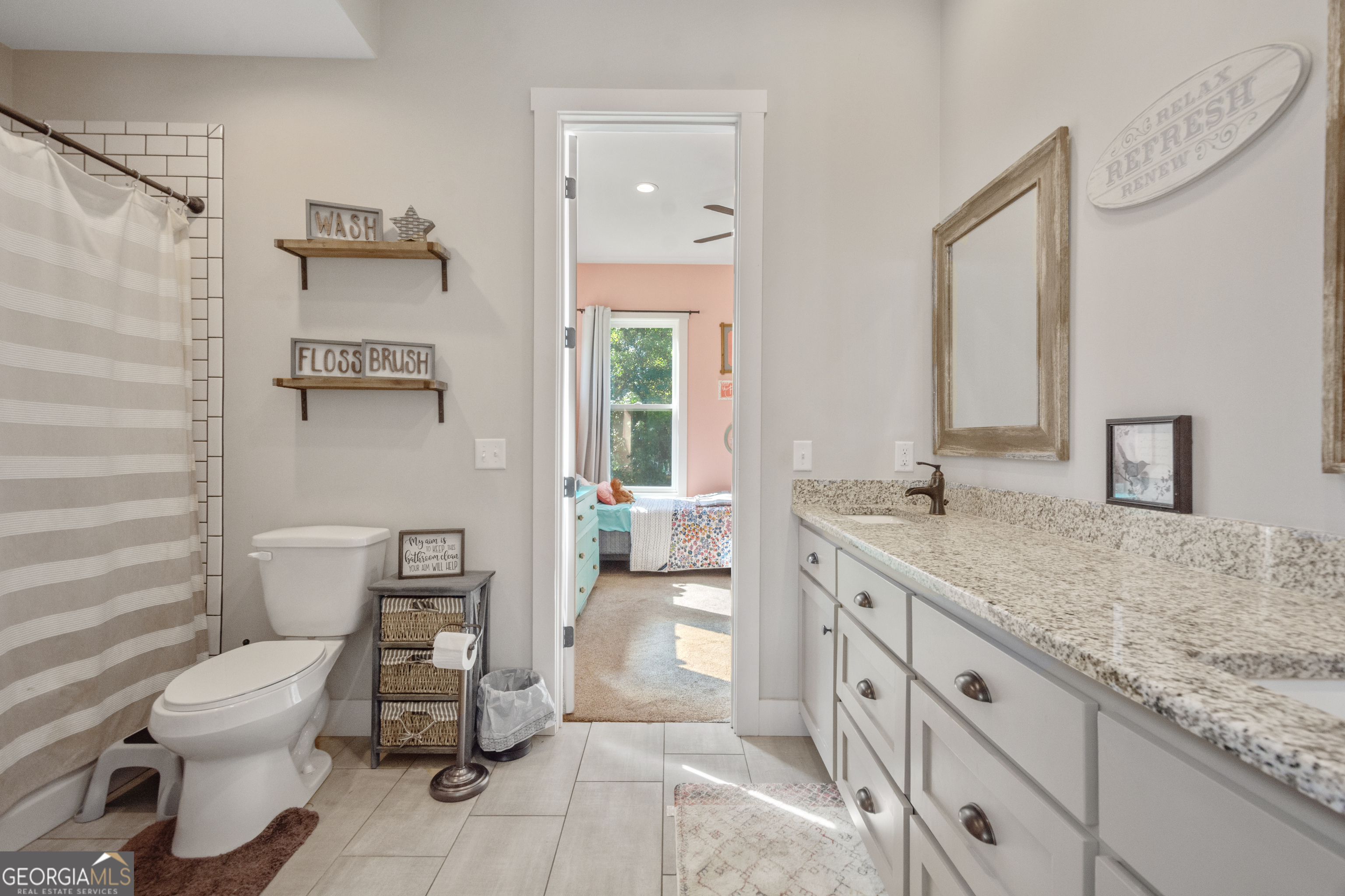 221 Butler Road Southeast Milledgeville, GA 31061 - Photo 45 of 60 a bathroom with a granite countertop sink mirror vanity and toilet
