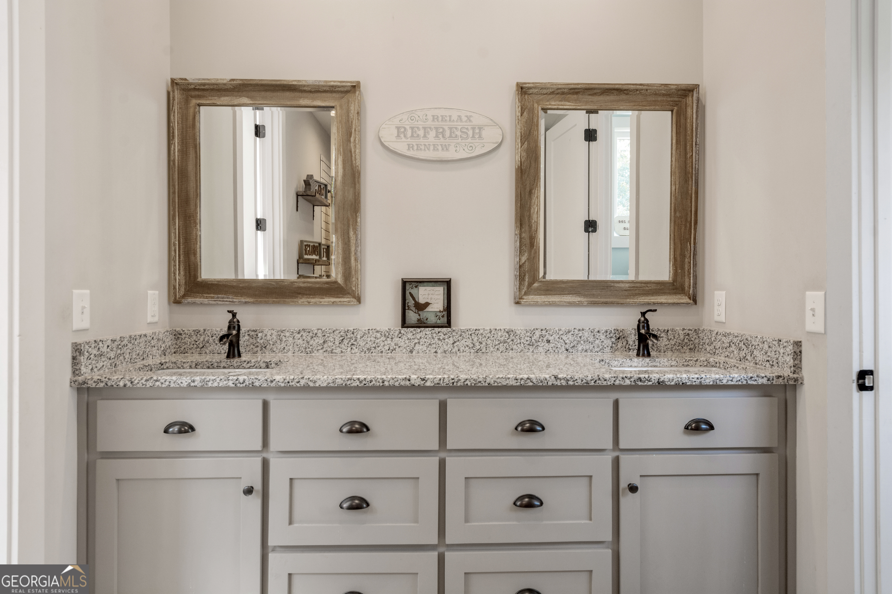 221 Butler Road Southeast Milledgeville, GA 31061 - Photo 46 of 60 a bathroom with a granite countertop double vanity sink and a mirror