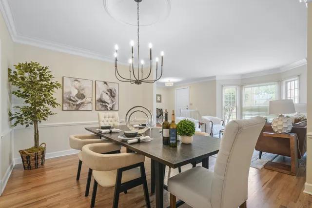 a view of a dining room with furniture wooden floor and chandelier