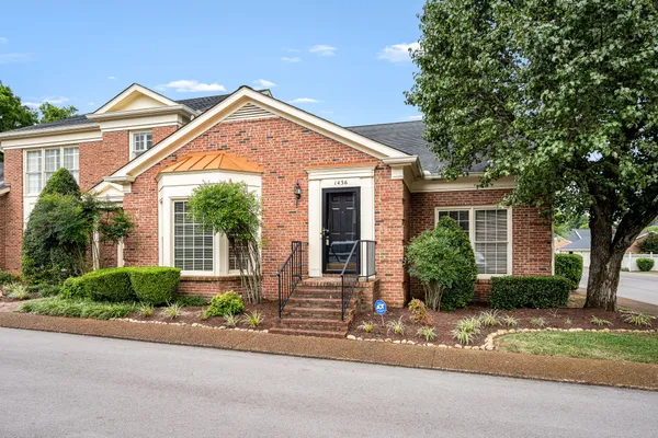 front view of a house and a small yard