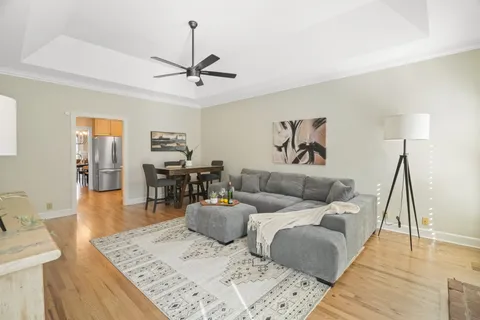 a living room with furniture and wooden floor