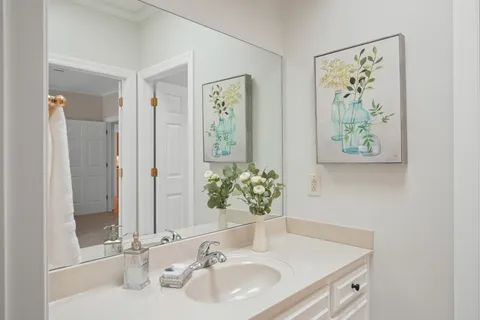 a bathroom with a granite countertop sink a toilet and a bathtub