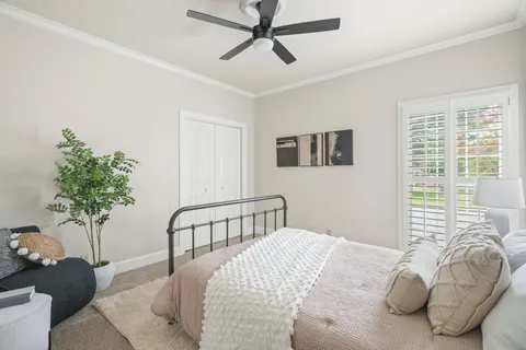 a bedroom with a bed and a chandelier