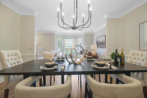 a view of a dining room with furniture and a chandelier