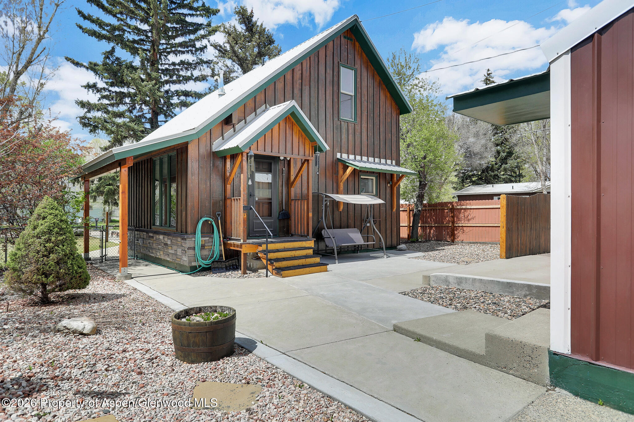 a view of backyard with wheel chair potted plants and wooden fence