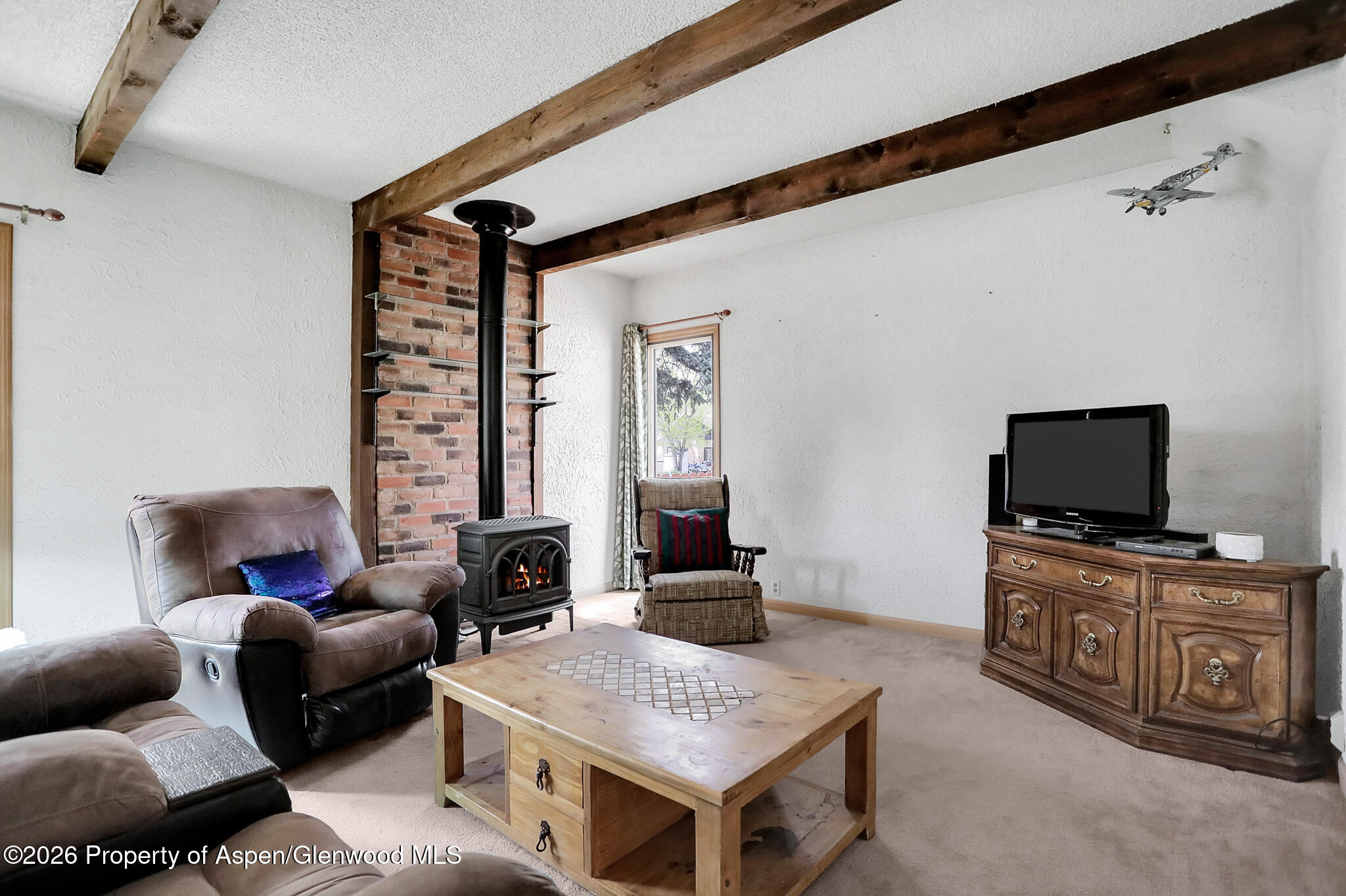 595 Colorado Street Craig, CO 81625 - Photo 12 of 31 a living room with furniture and a flat screen tv
