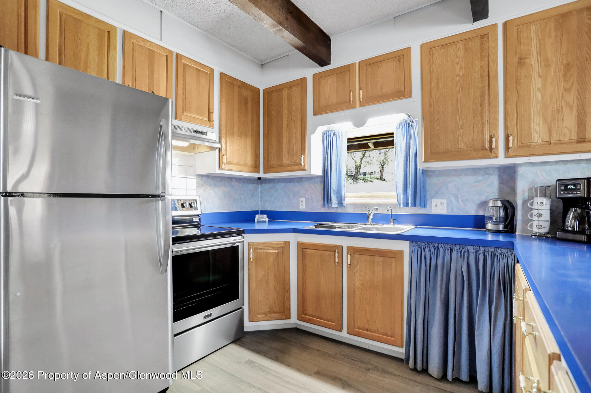 595 Colorado Street Craig, CO 81625 - Photo 16 of 31 a kitchen with stainless steel appliances granite countertop a stove a sink and a refrigerator