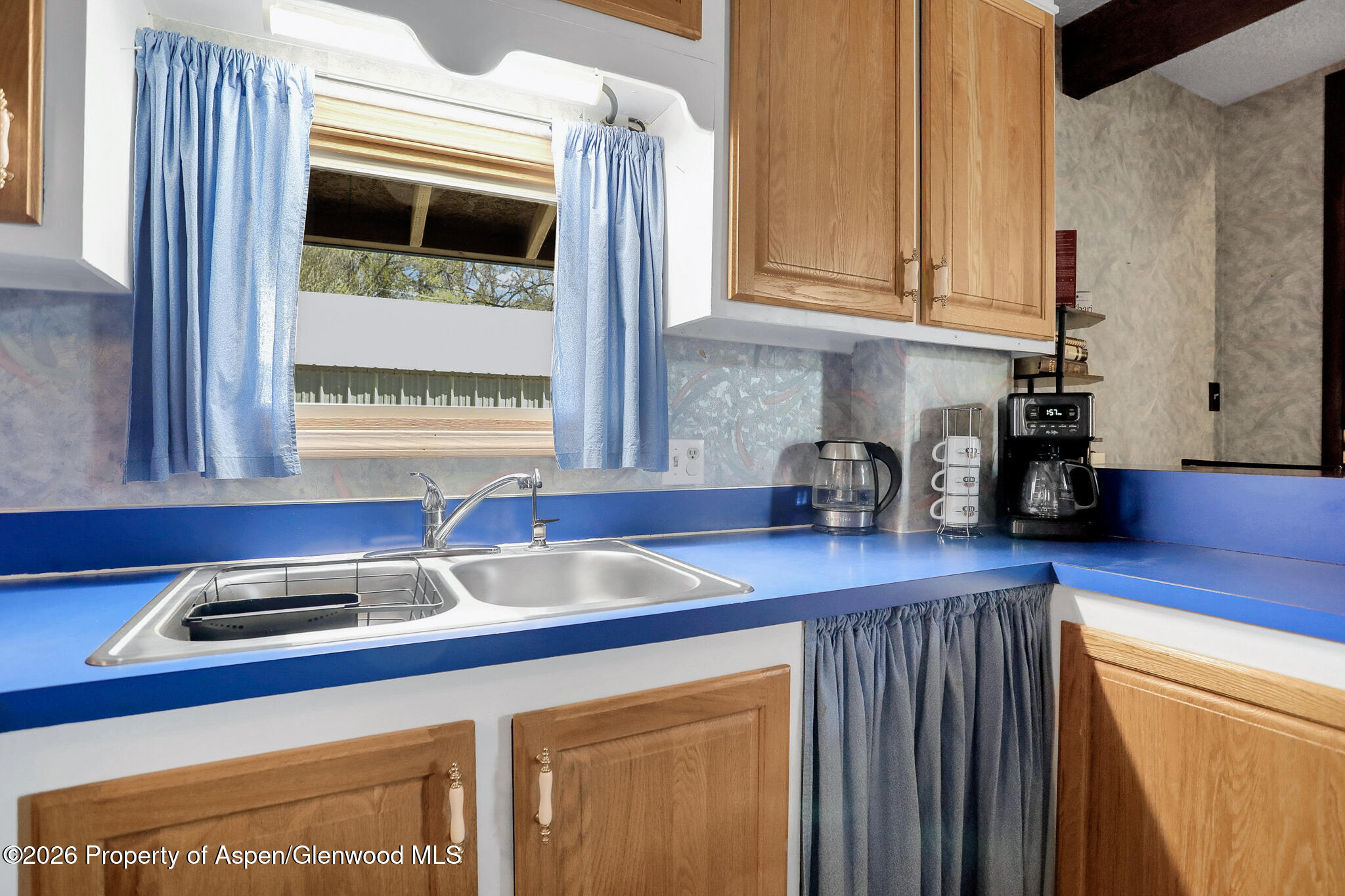 595 Colorado Street Craig, CO 81625 - Photo 17 of 31 a kitchen with stainless steel appliances a sink and cabinets