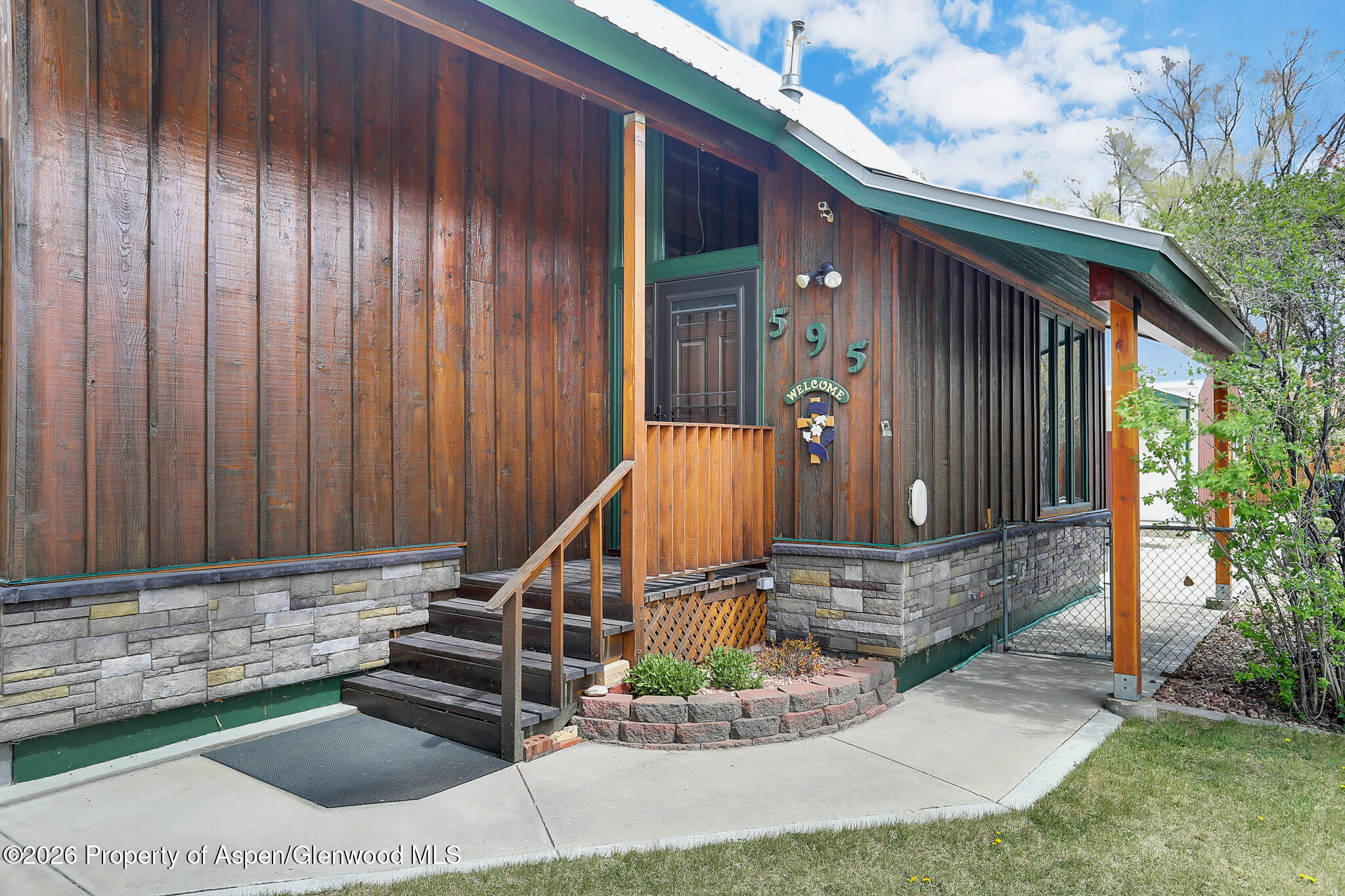 595 Colorado Street Craig, CO 81625 - Photo 2 of 31 a front view of a house with garden