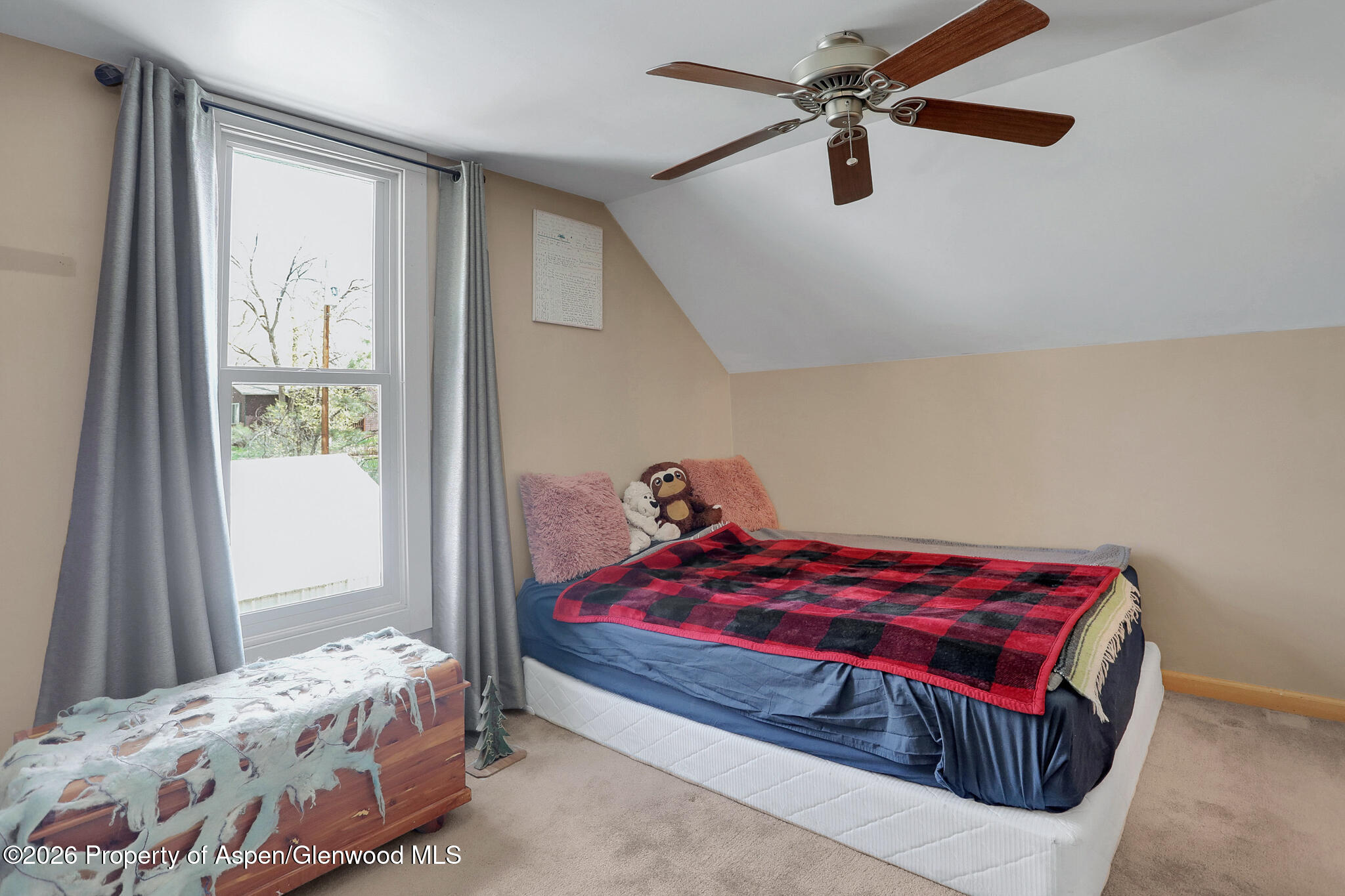 595 Colorado Street Craig, CO 81625 - Photo 21 of 31 a bedroom with a bed and a chandelier