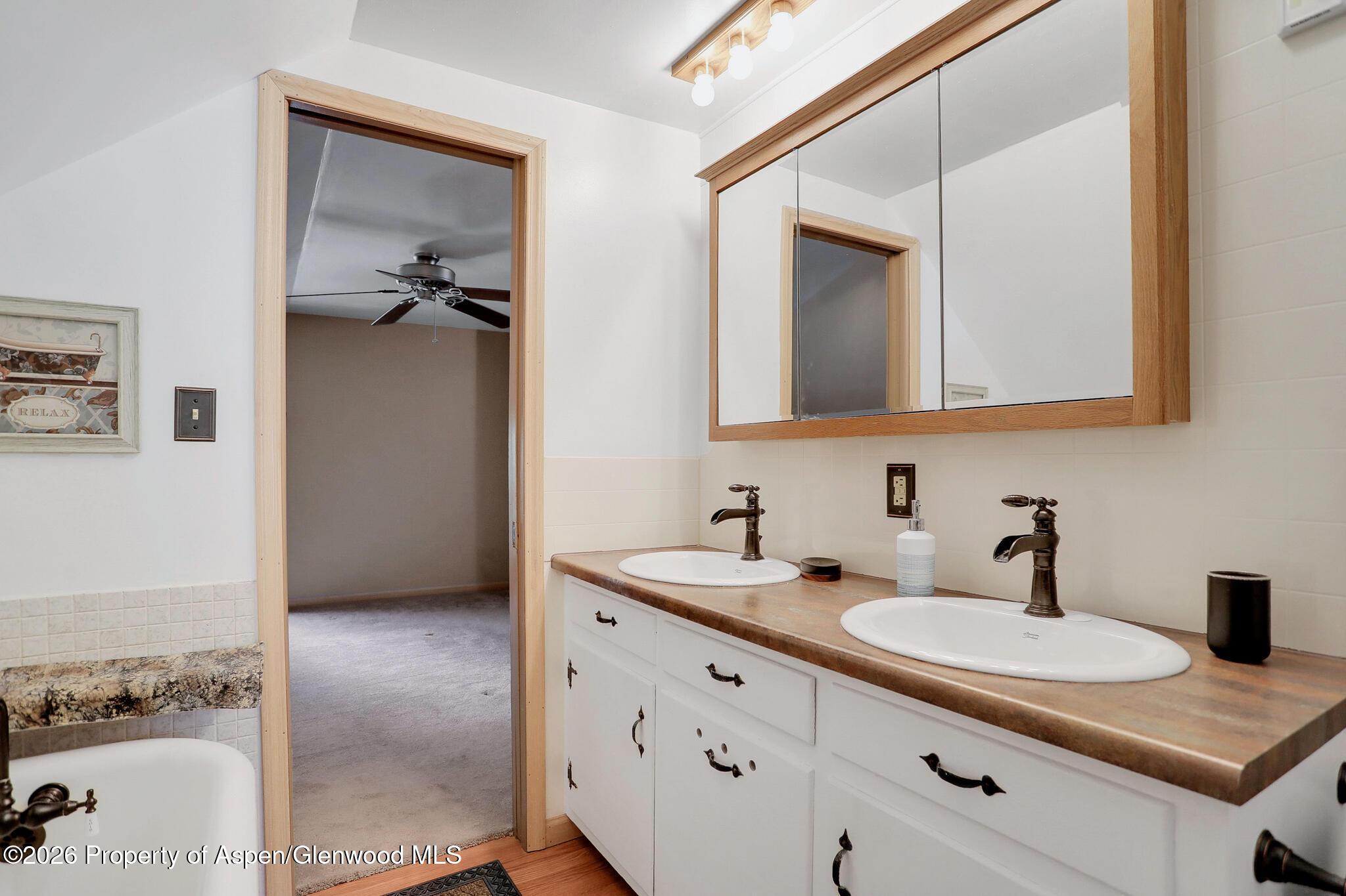 595 Colorado Street Craig, CO 81625 - Photo 26 of 31 a bathroom with a granite countertop sink and a mirror