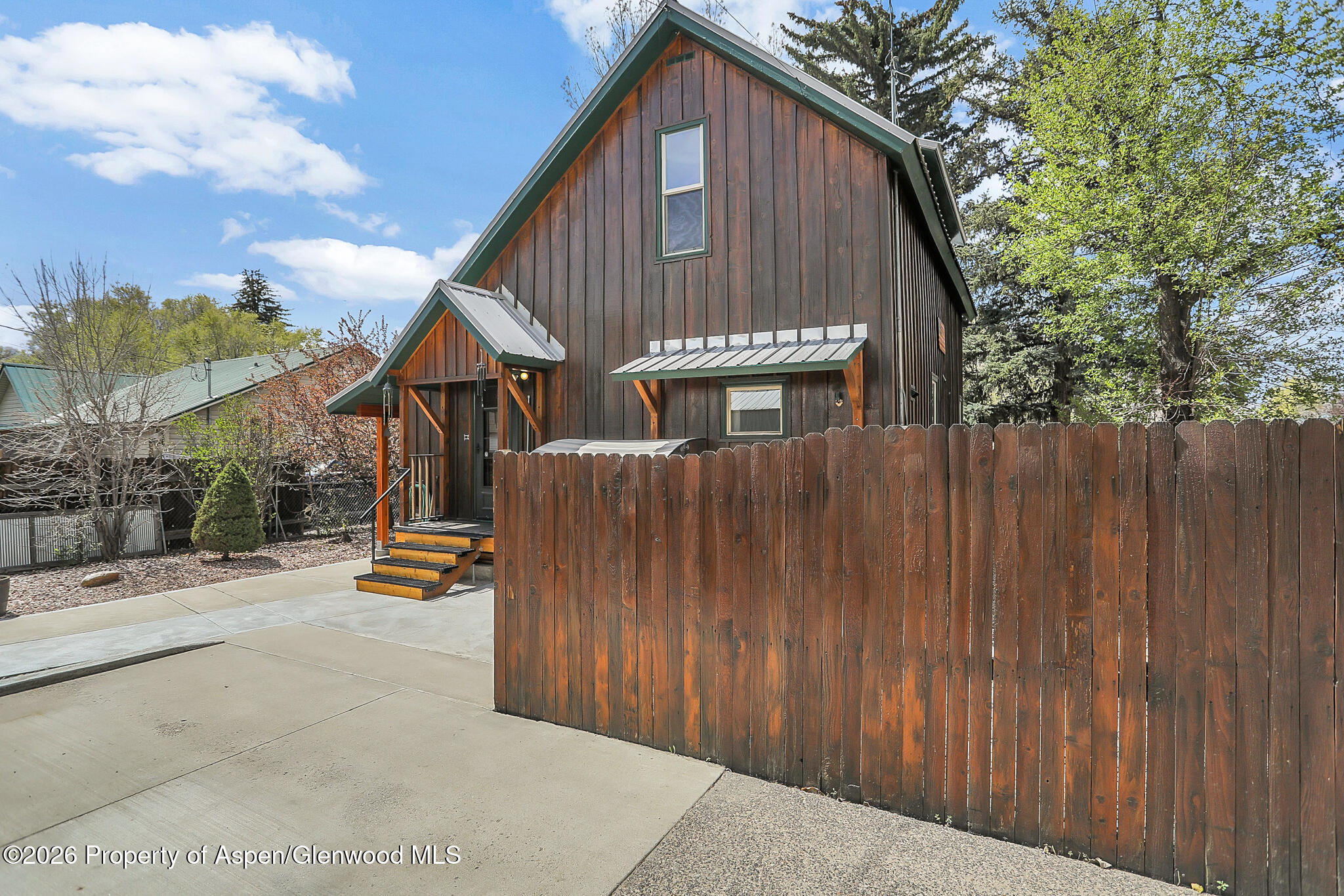 595 Colorado Street Craig, CO 81625 - Photo 4 of 31 a view of a house with wooden fence next to a road