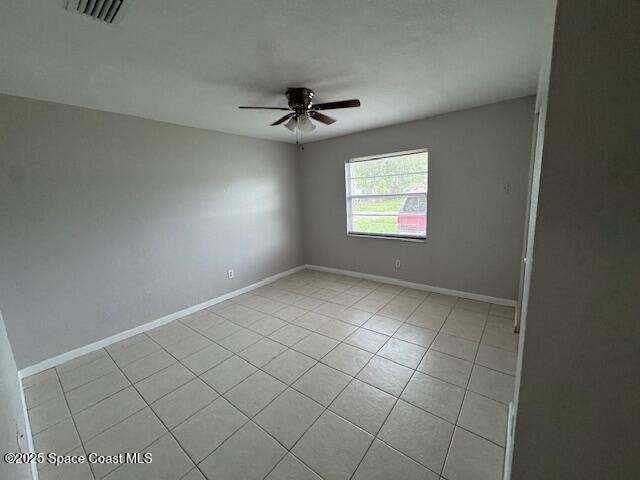2389 Victor Road Cocoa, FL 32926 - Photo 10 of 12 an empty room with windows and fan
