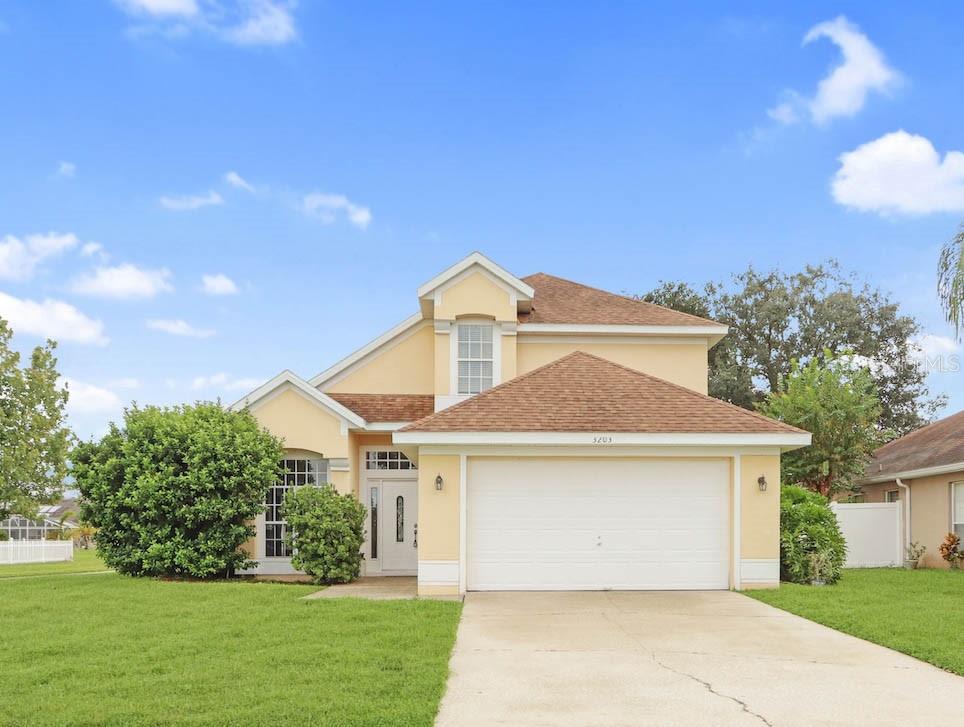 a front view of a house with a yard and garage