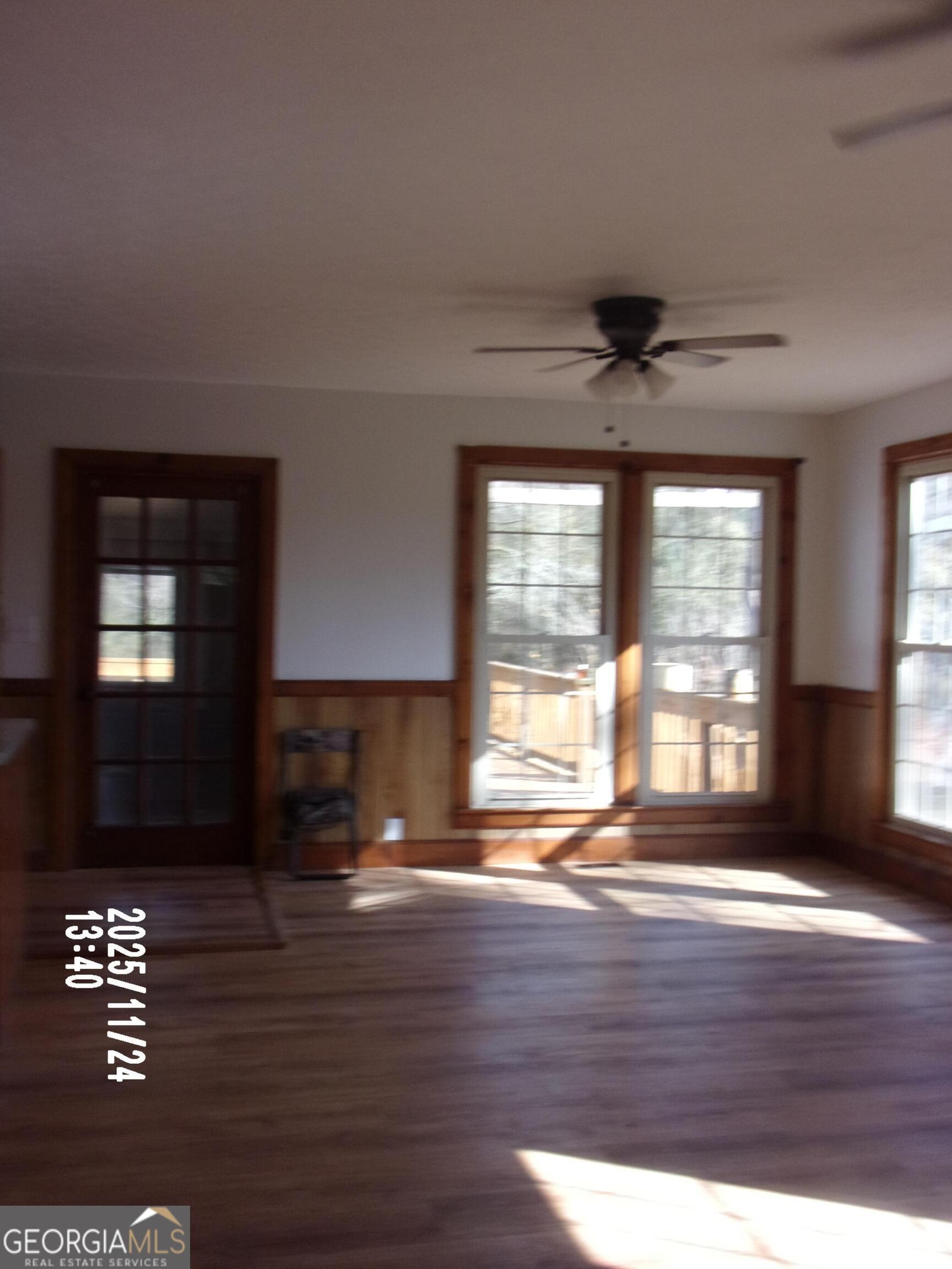 781 North Delray Road Thomaston, GA 30286 - Photo 39 of 63 an empty room with wooden floor and windows