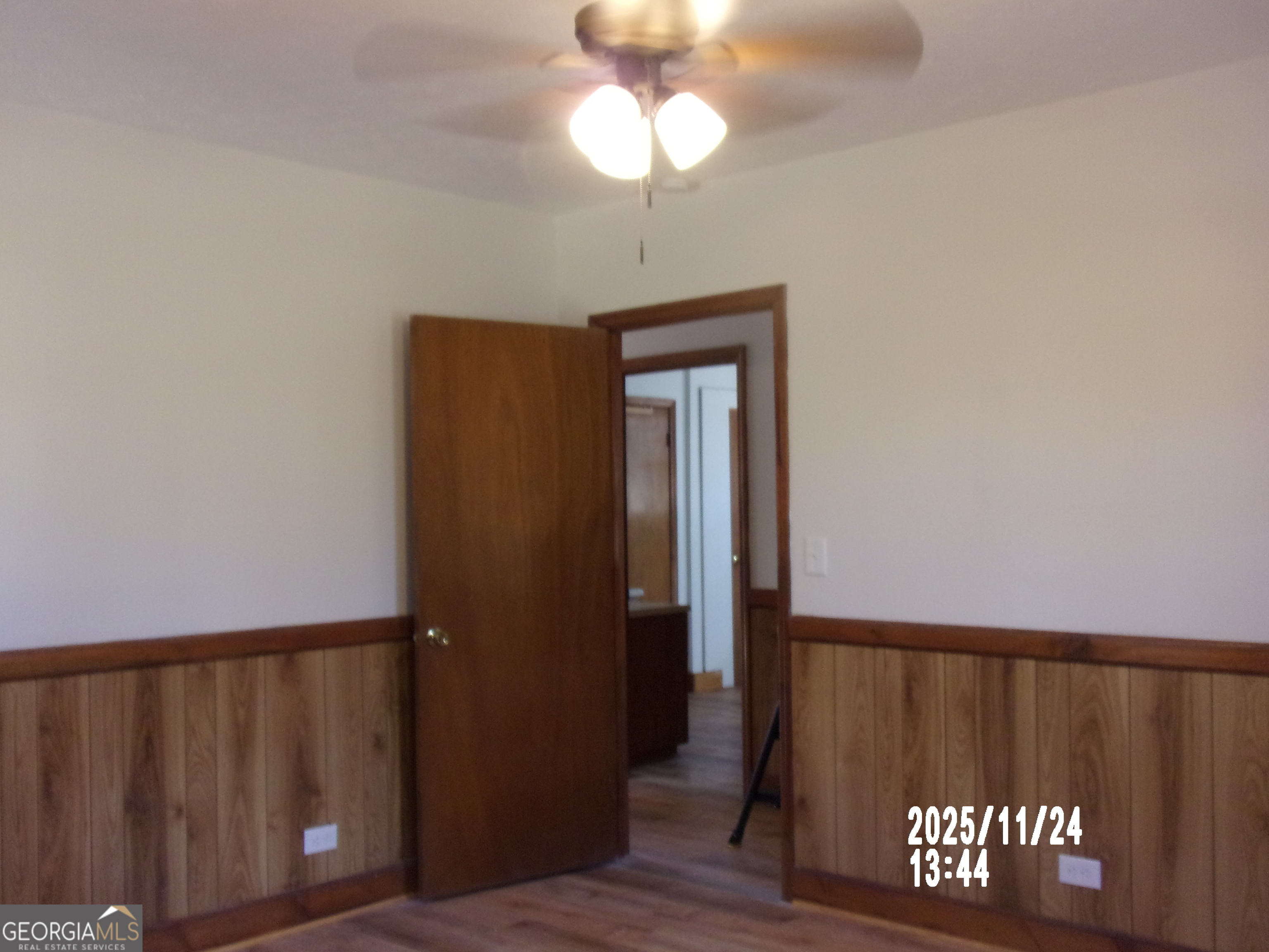 781 North Delray Road Thomaston, GA 30286 - Photo 49 of 63 a view of a hallway with wooden floor and chandelier