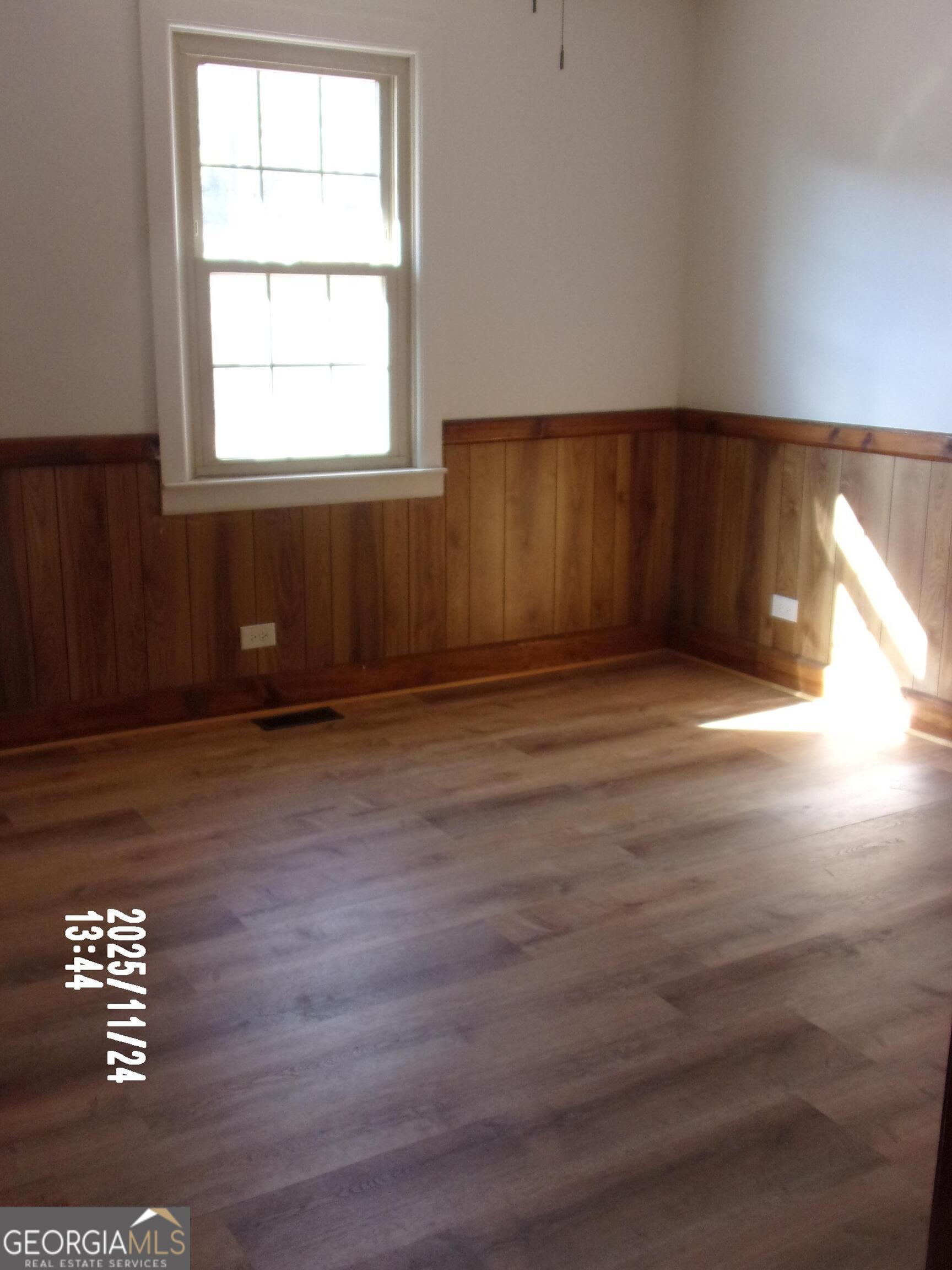 781 North Delray Road Thomaston, GA 30286 - Photo 50 of 63 an empty room with wooden floor and windows