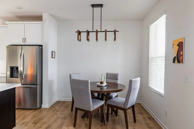 a view of a dining room with furniture window and wooden floor
