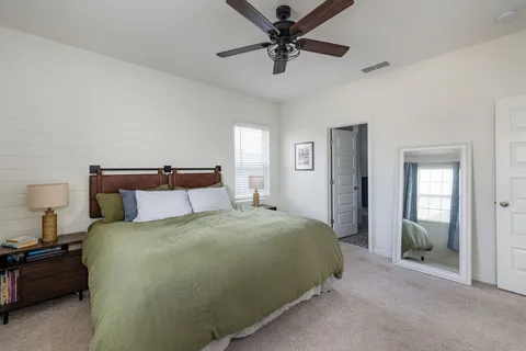 a bedroom with a bed and a chandelier