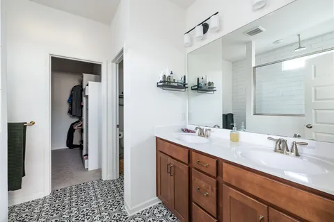 a bathroom with a sink a double vanity and a mirror