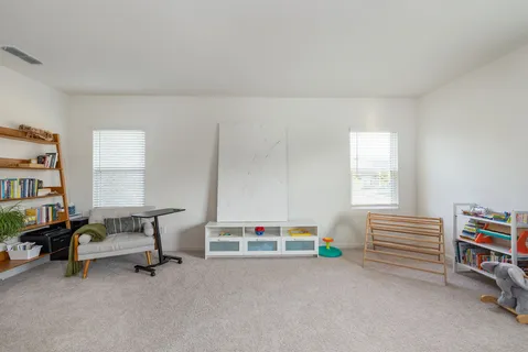 a reading room with furniture and a book shelf