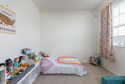 a bedroom with bed and a window