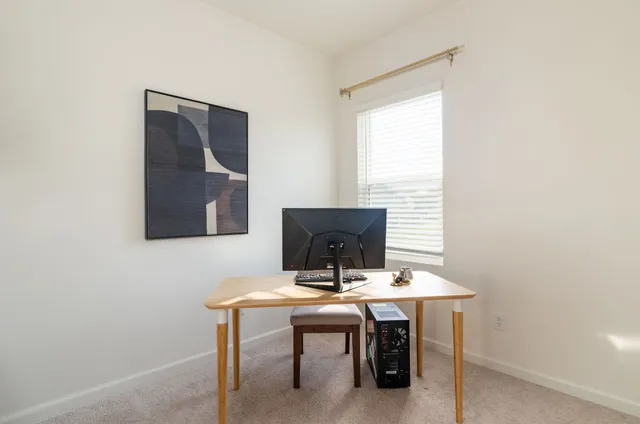 a view of a workspace with furniture