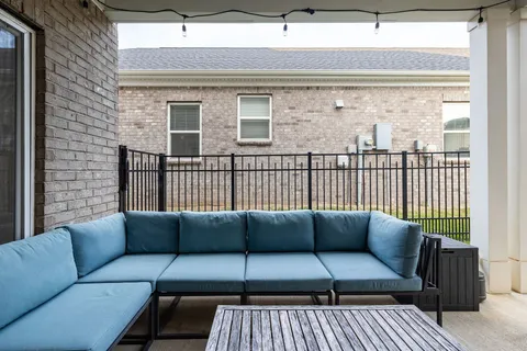 a balcony with furniture and a potted plant