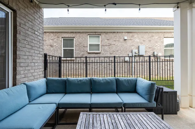 a balcony with furniture and a potted plant
